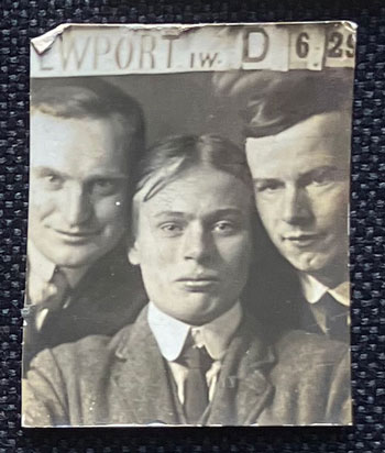 group portrait of three young men - large print studio sign